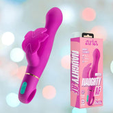 The Blush Novelties Aria Rechargeable Vibe Naughty AF-Plum, a vibrant pink vibrator with a leaf-shaped detail and RumboTech motors, is displayed beside its pink box against a soft pastel bokeh background.